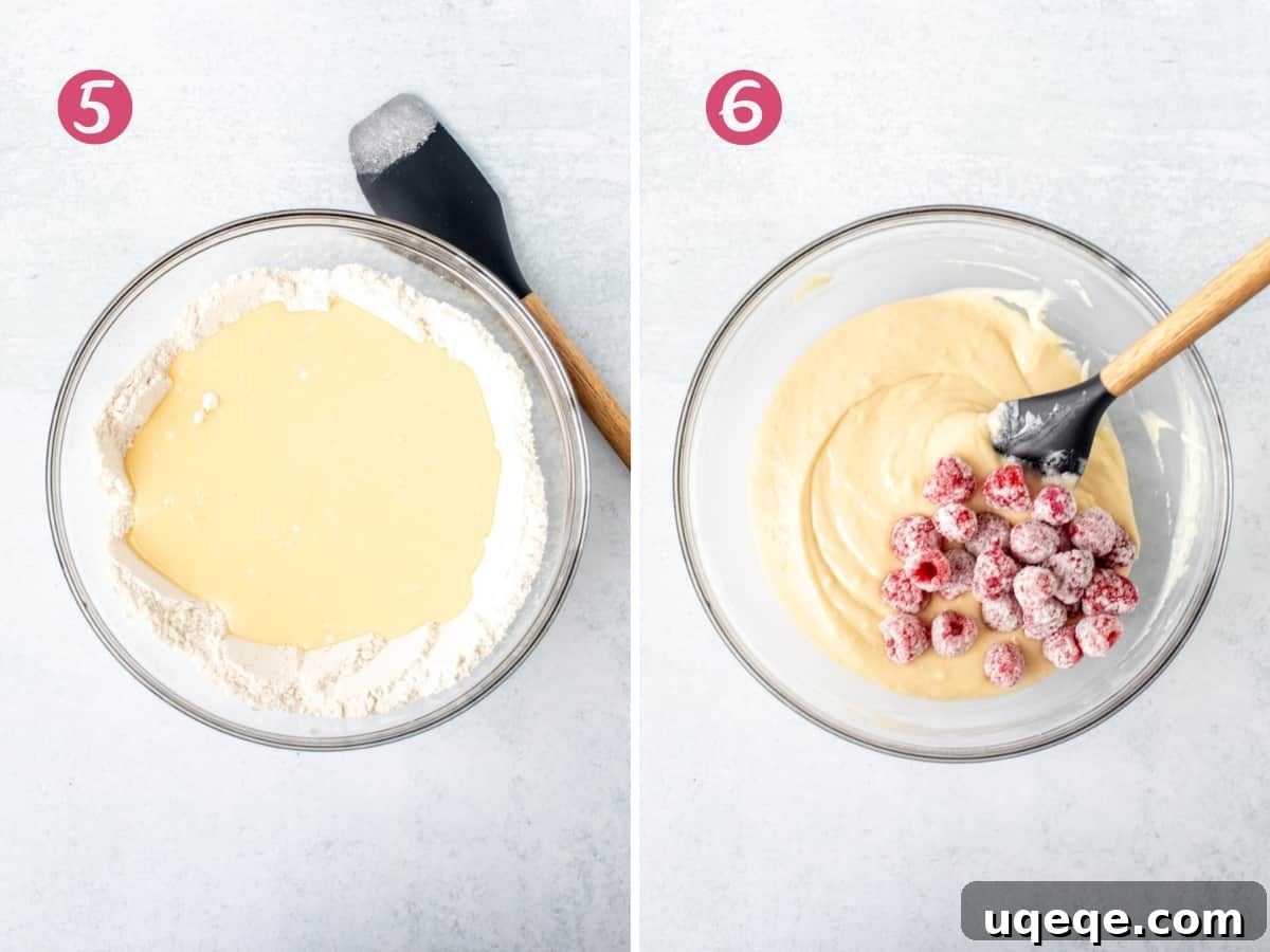 Wet ingredients poured into dry ingredients, followed by raspberries gently folded into the lemon loaf batter.