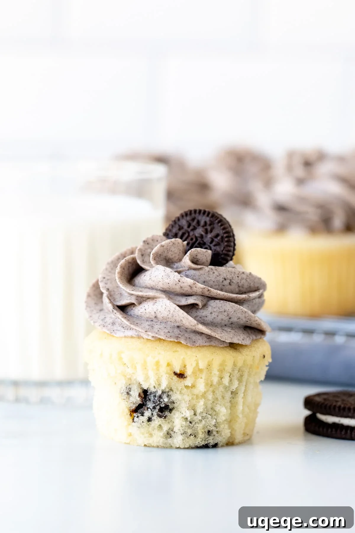 Oreo cupcake with Oreo frosting with a glass of milk