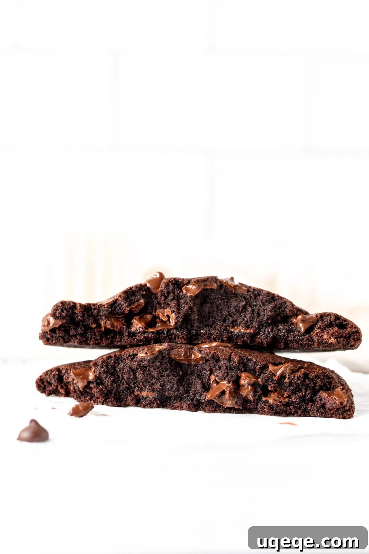 Solo Chocolate Delight 3 Giant chocolate cookie for one broken in half, showcasing its rich texture and abundance of chocolate chips and gooey center.