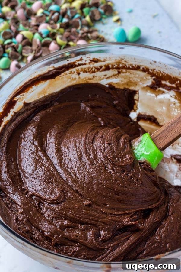 Ingredients for chocolate fudge recipe, featuring marshmallow cream for extra creaminess, arranged on a kitchen counter.