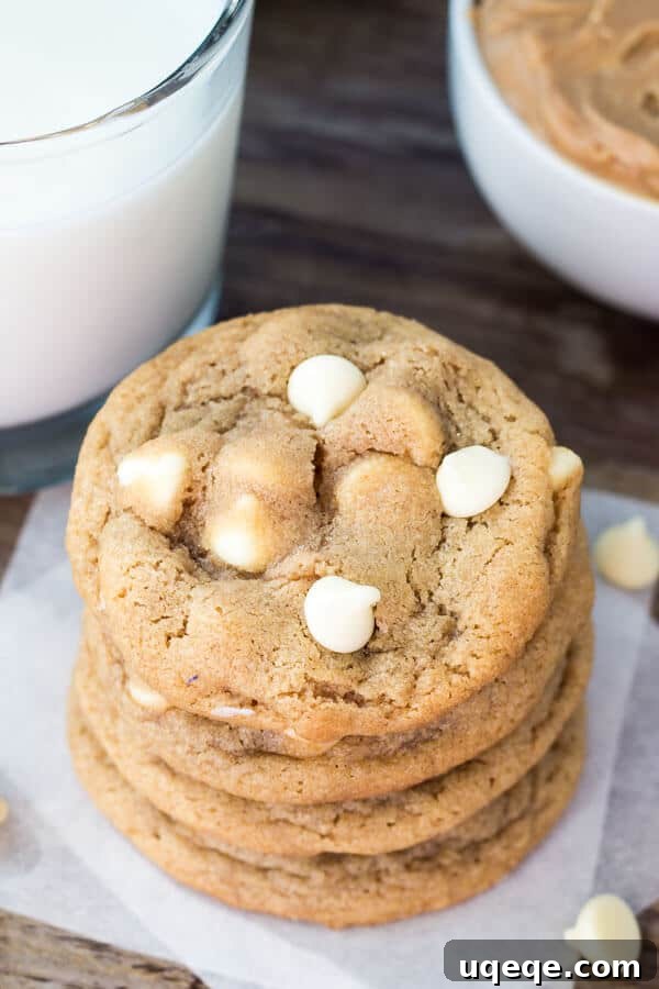 Peanut Butter White Chocolate Chip Delights 2 Overhead shot of a stack of peanut butter white chocolate chip cookies. Glass of milk and bowl of peanut butter in the background