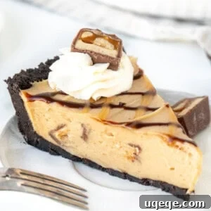 Slice of Snickers pie topped with caramel and hot fudge sauce and a dollop of whipped cream