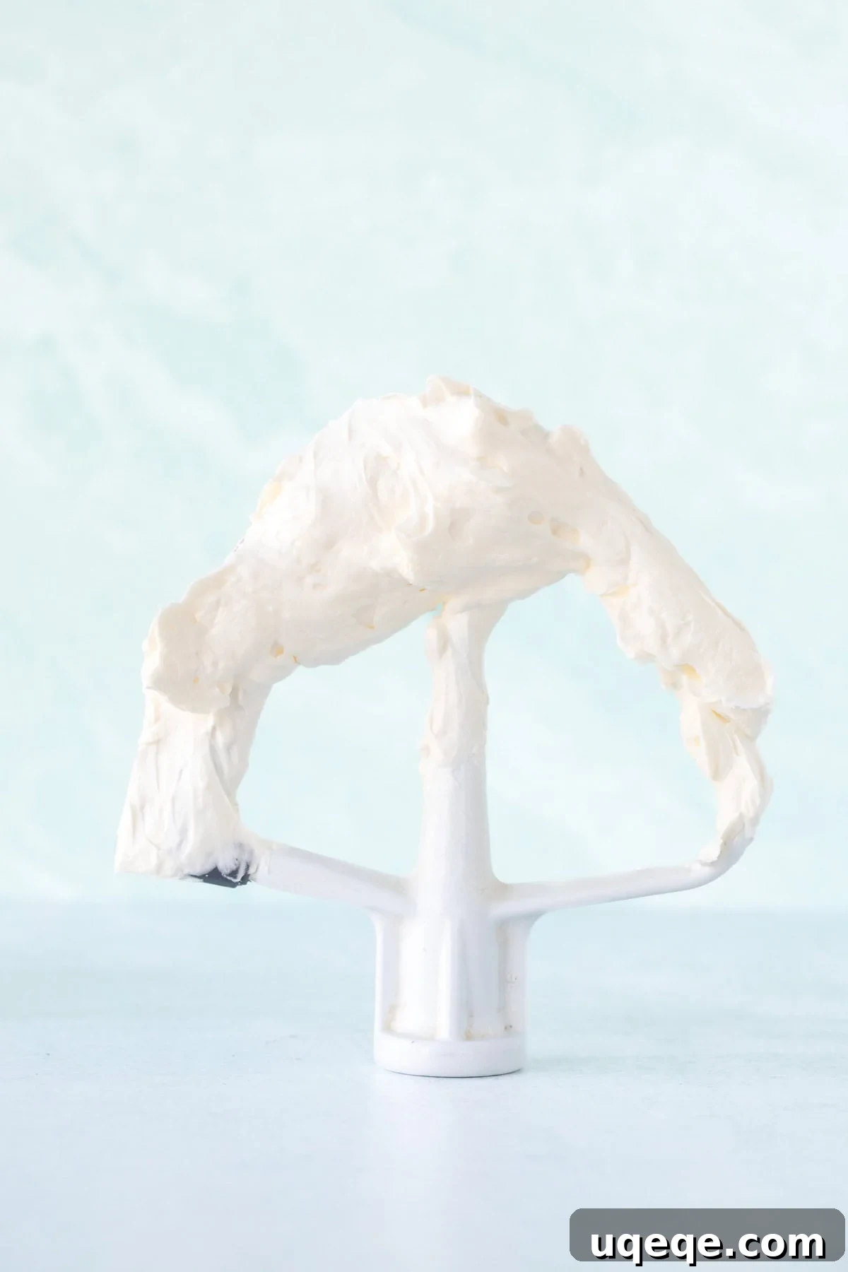 Silky Swiss Buttercream 9 Beater of a stand mixer covered in smooth Swiss meringue frosting, ready for use