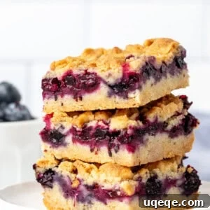 Golden Blueberry Streusel Bars 9 Stack of three blueberry crumble bars