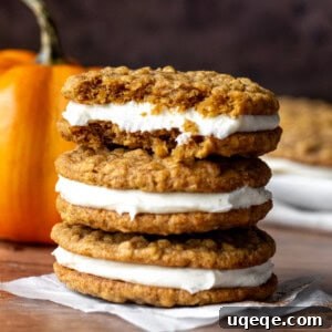 Three stacked pumpkin oatmeal cream pies, with top cookie broken in half