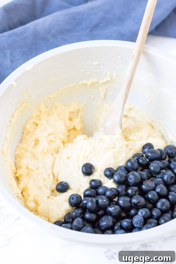 Sunshine Lemon Blueberry Muffins 4 Lemon blueberry muffin batter in a bowl.