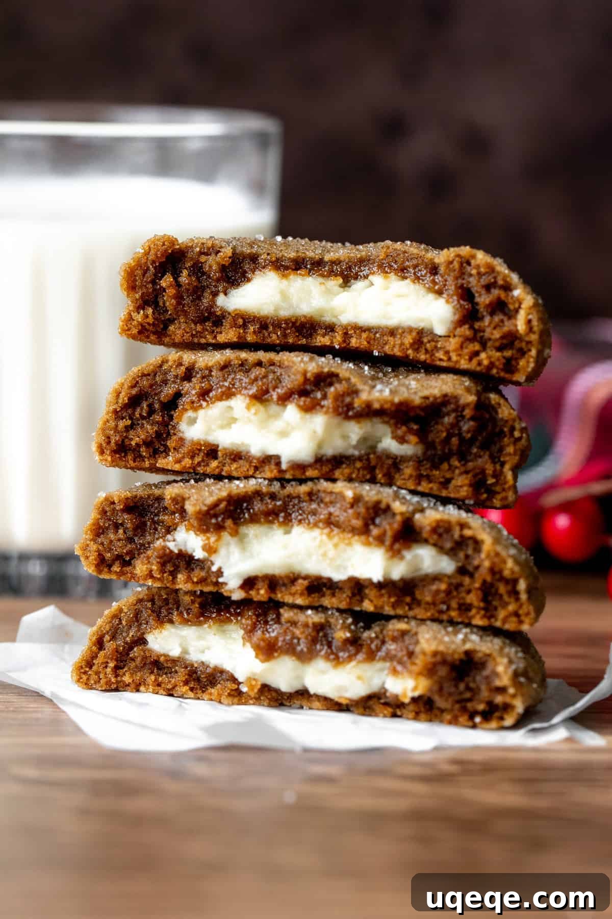 Gingerbread Cheesecake Delights 2 Gingerbread cheesecake cookies, broken in half to reveal the creamy filling, stacked elegantly