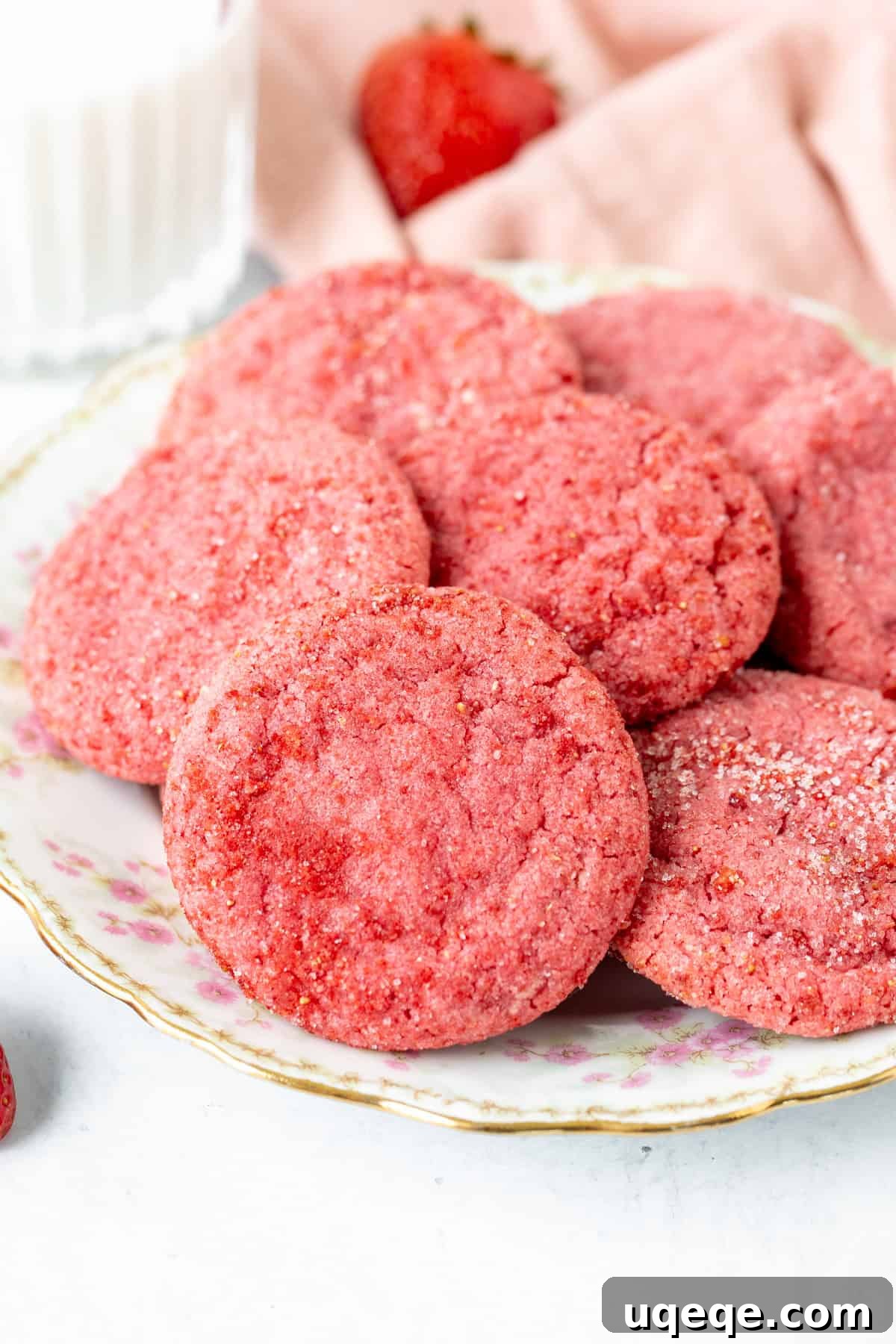 Rosy Strawberry Sugar Cookies 3 A charming plate filled with freshly baked strawberry sugar cookies, showcasing their inviting texture and beautifully sugared tops. They are ready to be sampled.