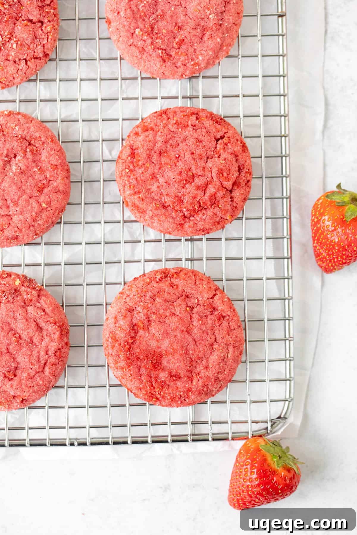 Rosy Strawberry Sugar Cookies 9 A beautiful array of freshly baked strawberry sugar cookies arranged neatly on a wire cooling rack, allowing them to cool completely before being stored or enjoyed.