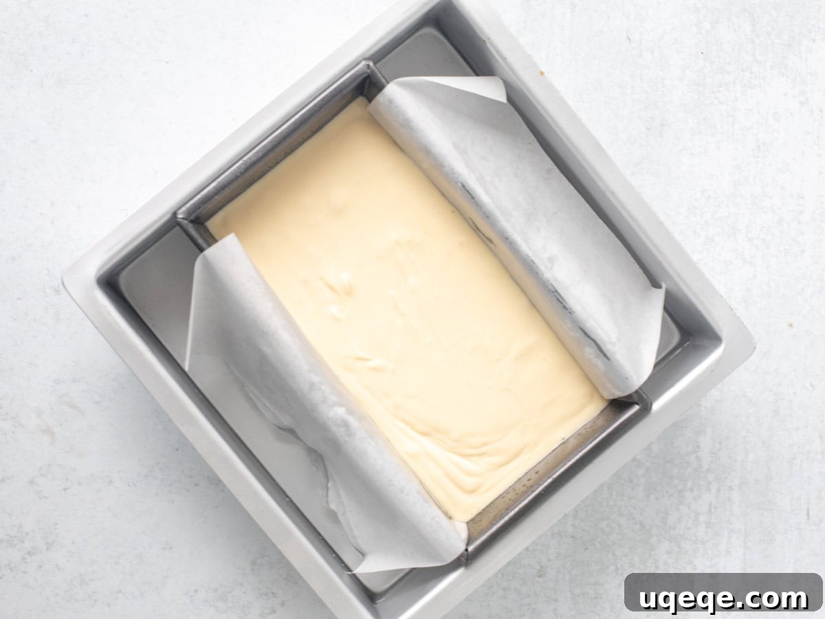Intimate Batch Cheesecake 6 Loaf pan with cheesecake batter placed in a larger baking pan filled with boiling water, ready for a water bath.