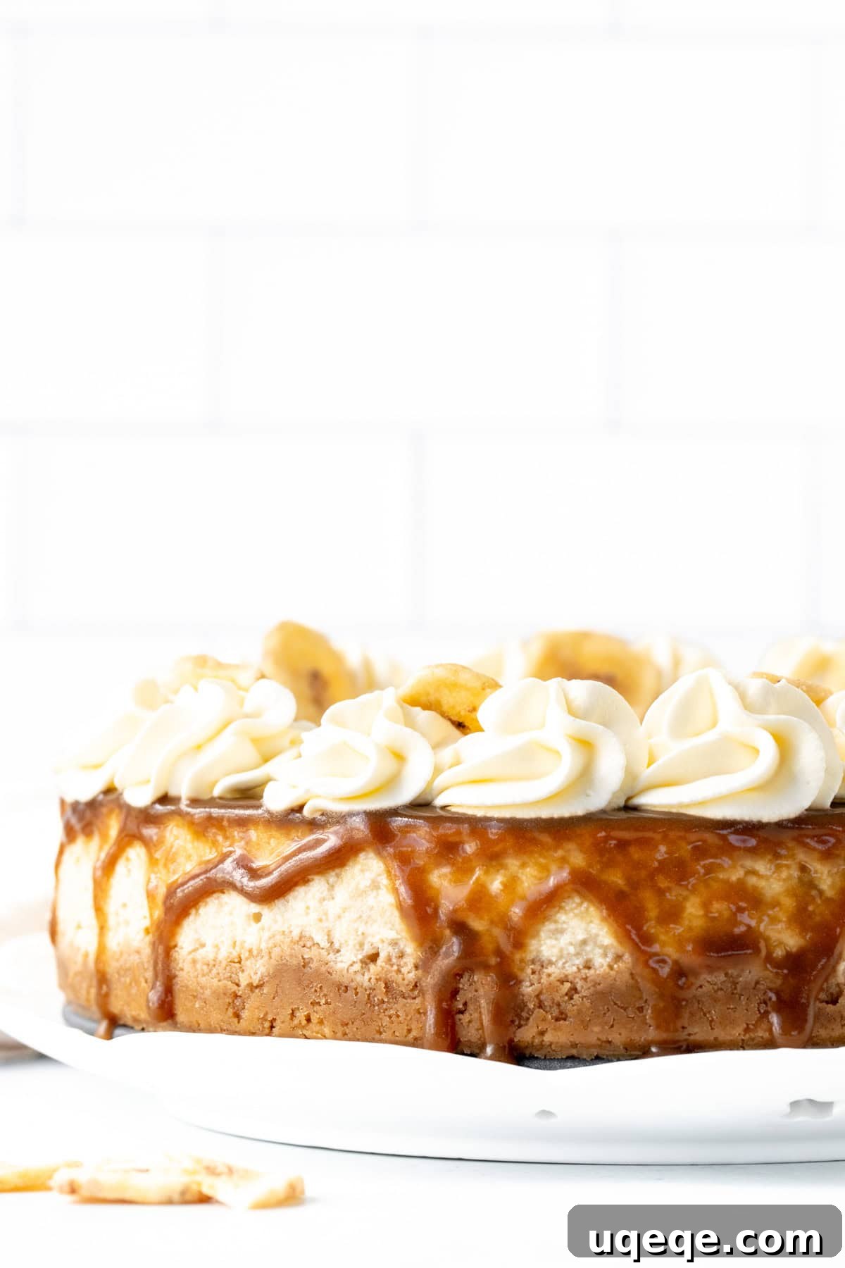 Decadent Banoffee Cheesecake 7 A beautiful banoffee cheesecake, freshly topped with golden caramel sauce, creating tempting rivulets down its sides.