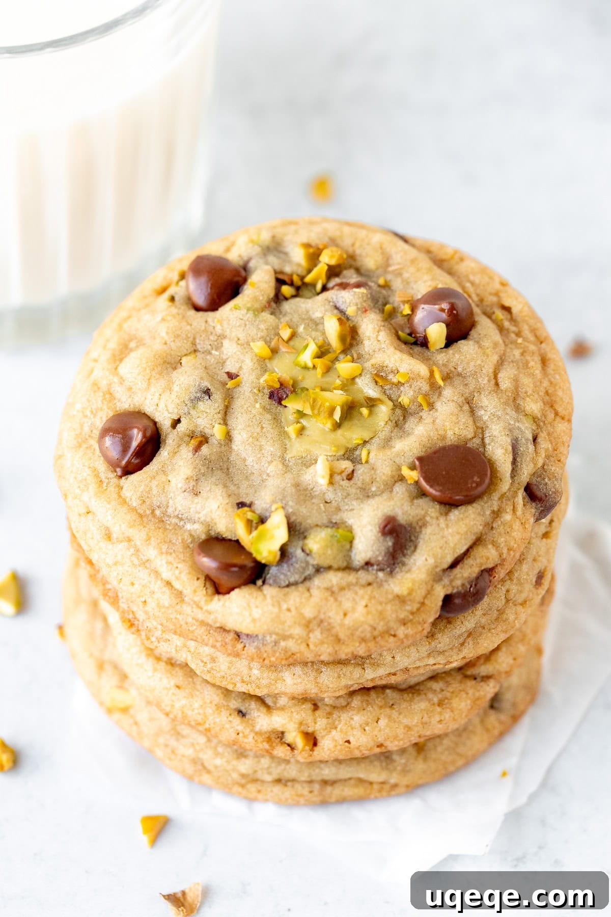 Pistachio Dream Chocolate Chip Cookies 2 Stack of freshly baked pistachio chocolate chip cookies, soft and chewy with visible pistachios, chocolate chips, and a hint of the creamy pistachio filling