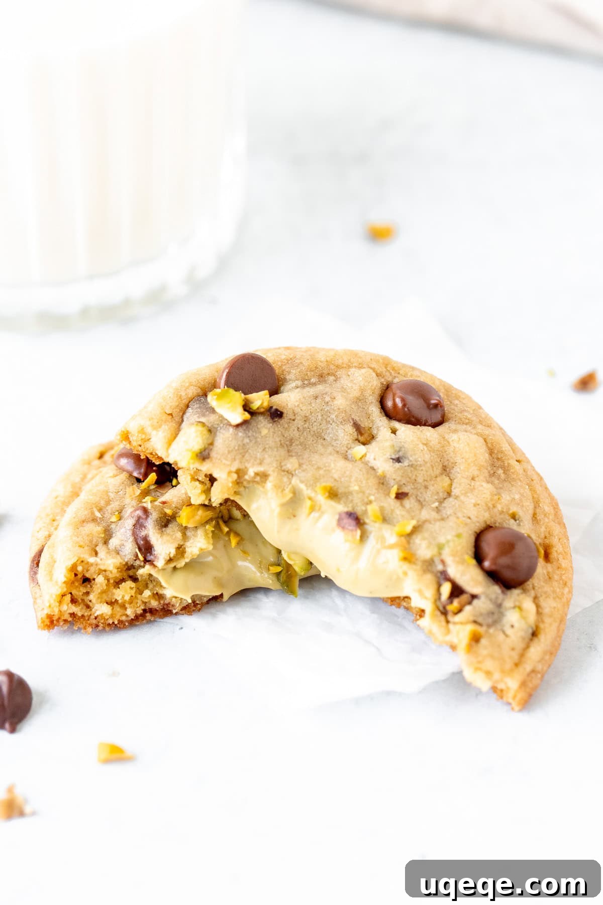 Pistachio Dream Chocolate Chip Cookies 9 A freshly baked pistachio chocolate chip cookie, broken in half to beautifully display the warm, gooey pistachio cream spread inside