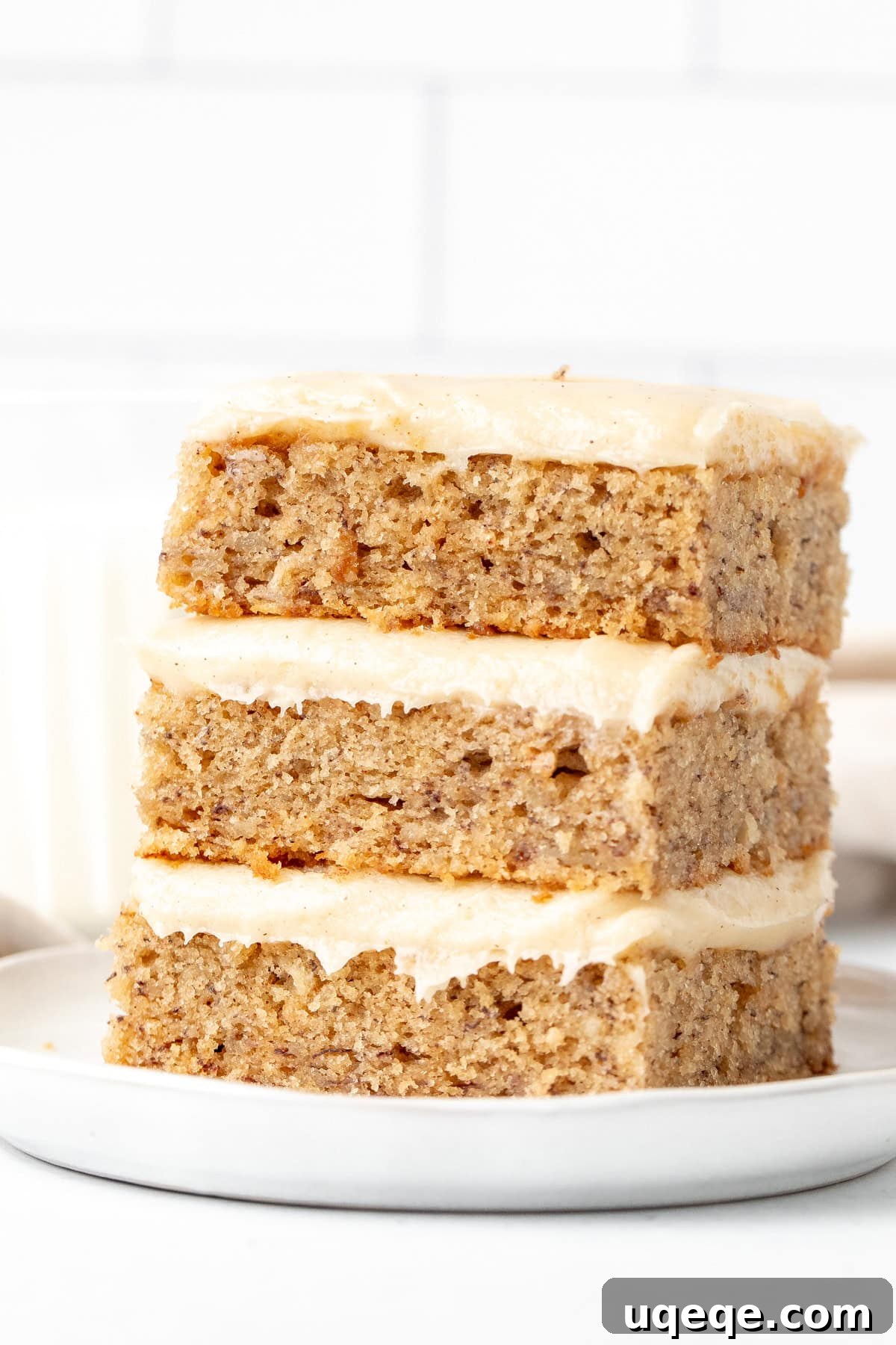 Frosted Banana Dream Bars 8 A delicious stack of three tender banana bars, each generously layered with creamy cinnamon cream cheese frosting