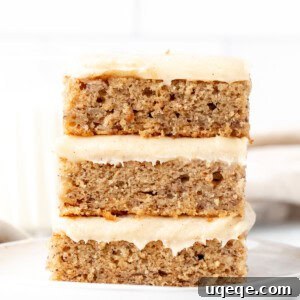 Three banana bars with cream cheese frosting, one on top of each other