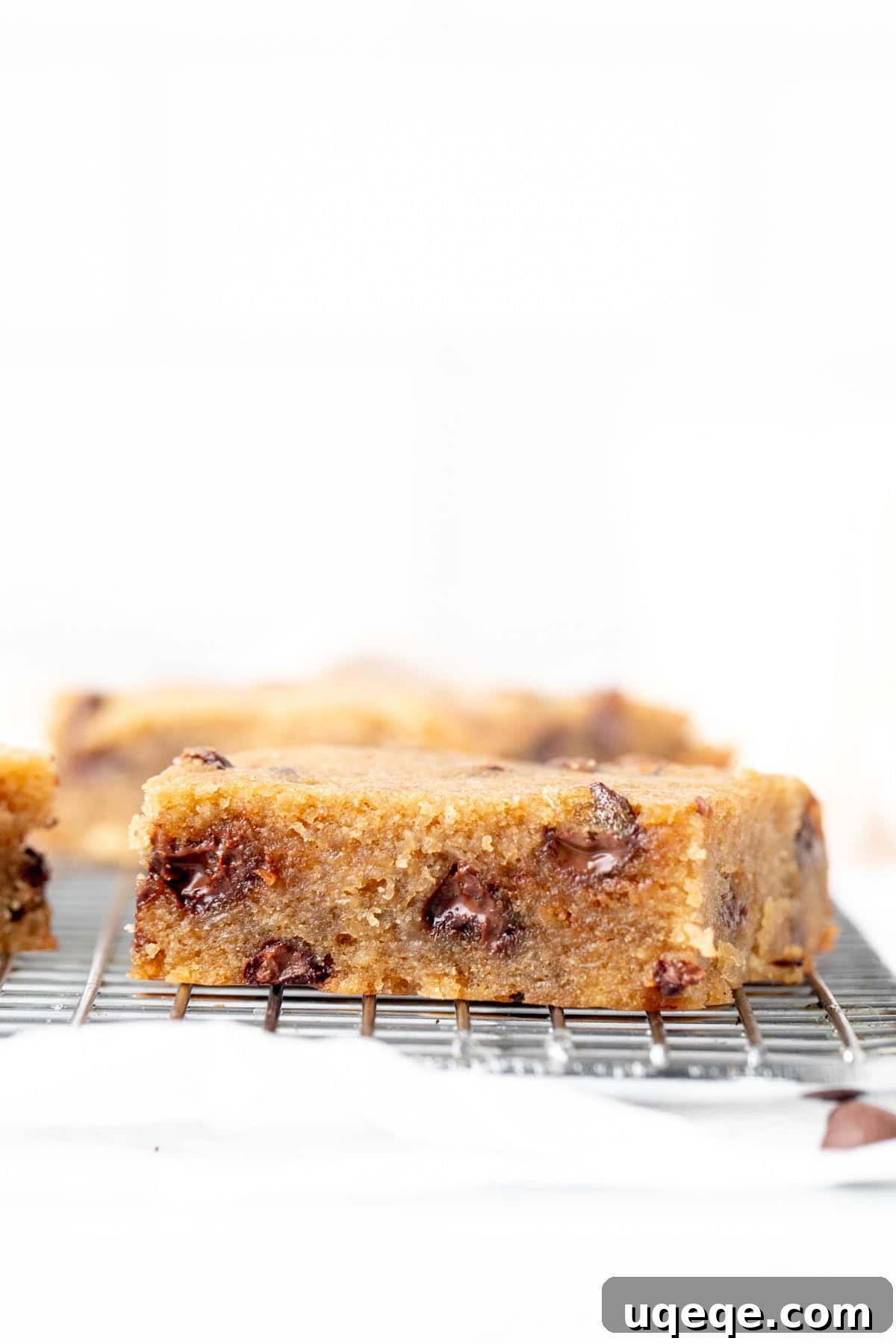Golden Banana Chocolate Chip Bars 3 A single chocolate chip banana bar placed on a cooling rack, showing its golden-brown top and soft interior