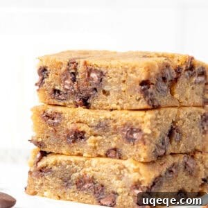 Golden Banana Chocolate Chip Bars 8 Three banana blondies with chocolate chips, stacked on top of one another, showcasing their appealing golden-brown tops and soft interiors.