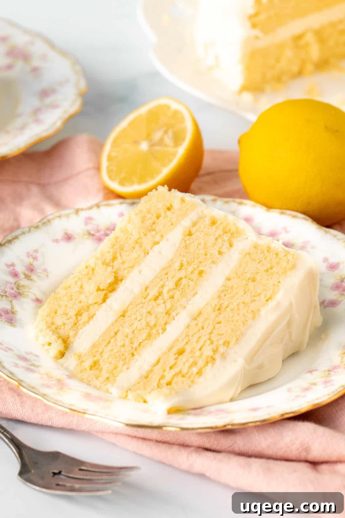Golden Lemon Delight 2 Slice of lemon layer cake with lemon frosting, showing moist crumb