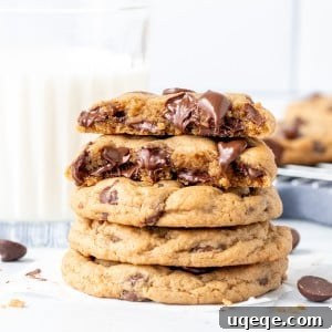 Stack of cream cheese chocolate chip cookies with top cookie broken in half.