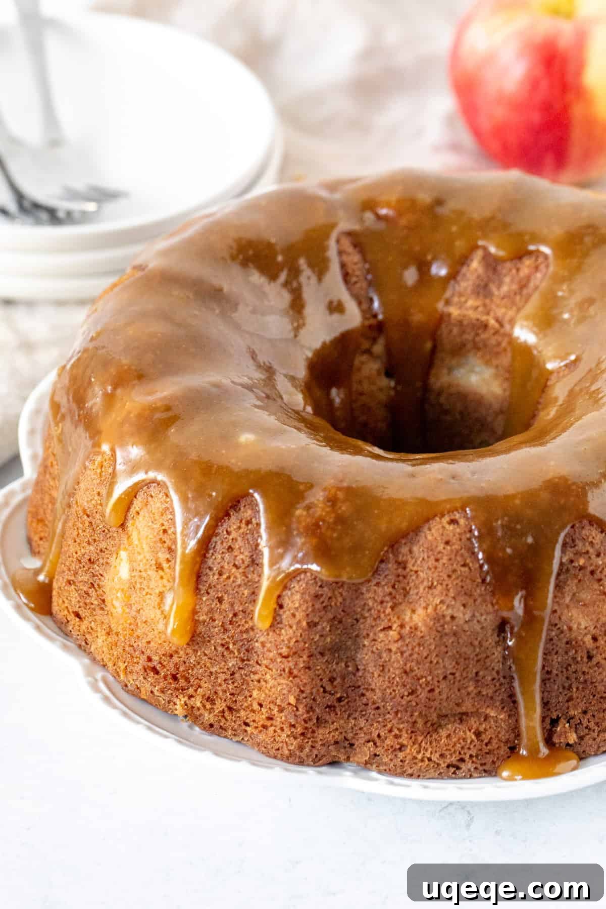 Autumn Apple Harvest Bundt 7 A perfectly baked and cooled 9-inch apple spice bundt cake, elegantly drizzled with a rich brown sugar glaze that cascades down its fluted sides.
