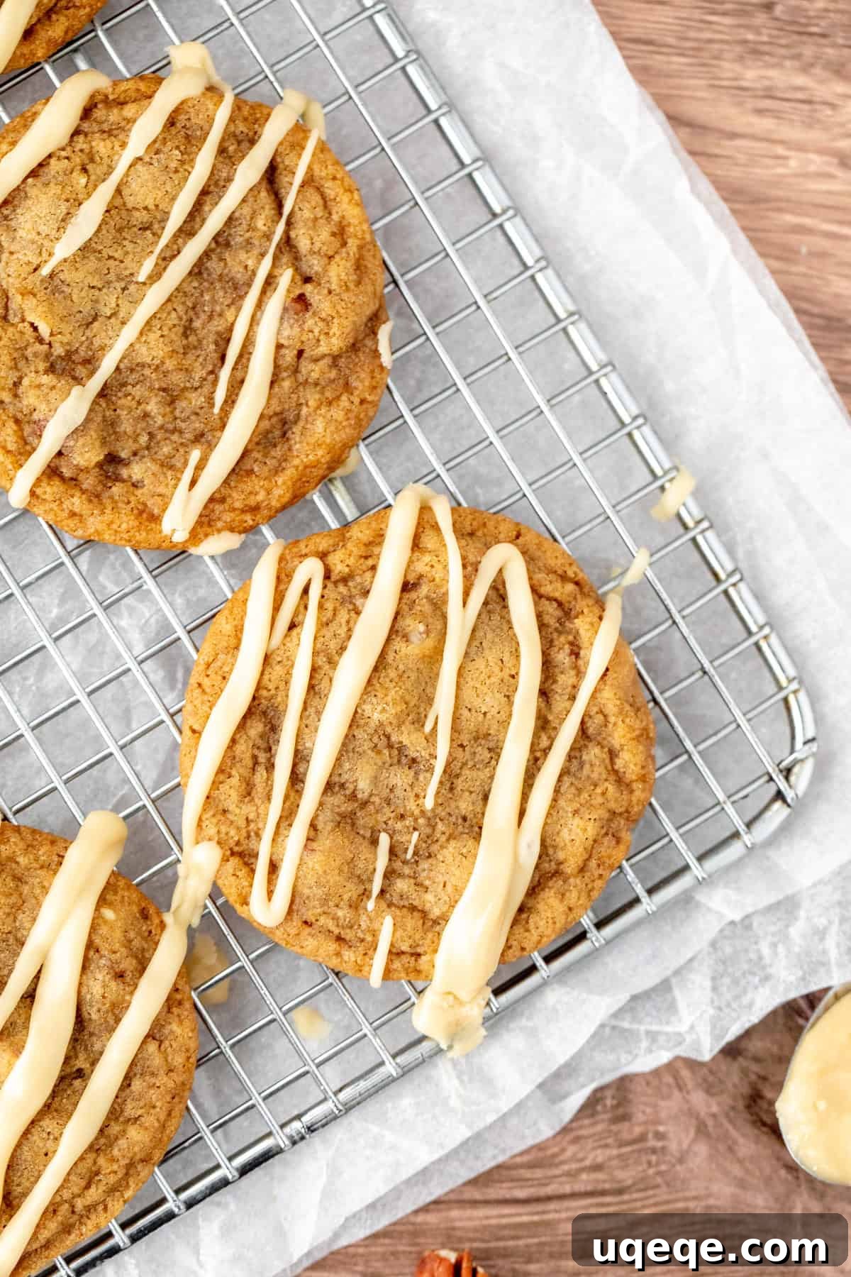 Double Maple Delight Cookies 6 Maple cookies arranged on a wire rack, freshly drizzled with a smooth maple glaze