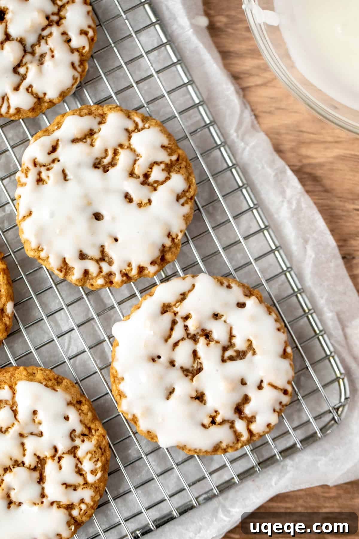 Glazed Oatmeal Delights 5 Freshly glazed oatmeal cookies arranged on a cooling rack, allowing the vanilla icing to harden.