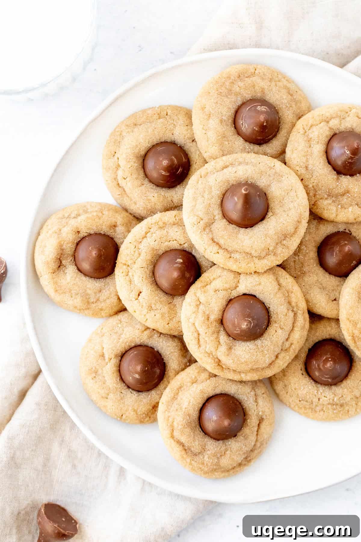 Peanut Butter Bliss Bites 8 A beautifully arranged platter of freshly baked peanut butter blossoms, showcasing their golden color and chocolate tops, ready for serving.