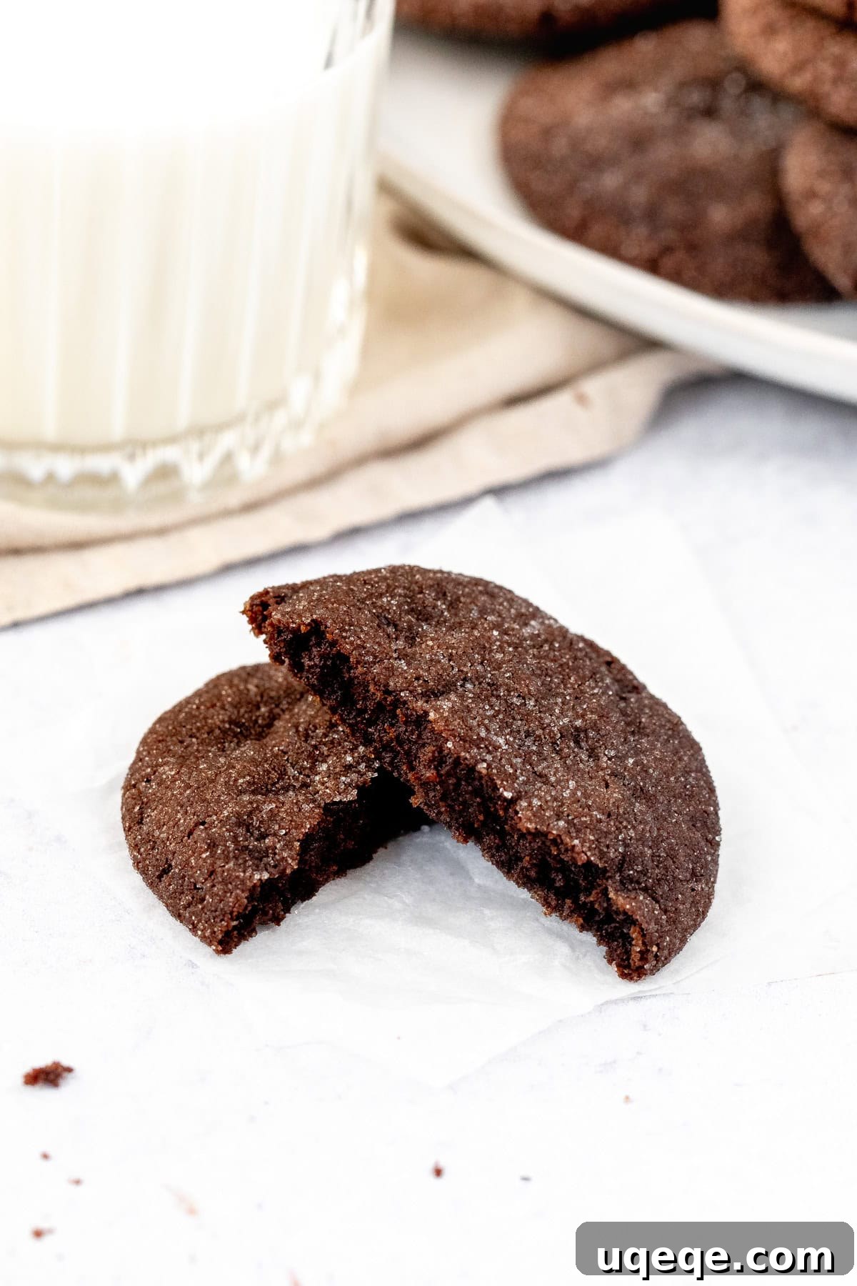 Cocoa Dream Cookies 7 A chocolate sugar cookie rolled in sugar, broken in half to reveal its chewy interior