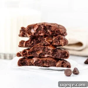 Small batch chocolate cookies, broken in half and stacked on top of one another, showcasing their inviting texture.