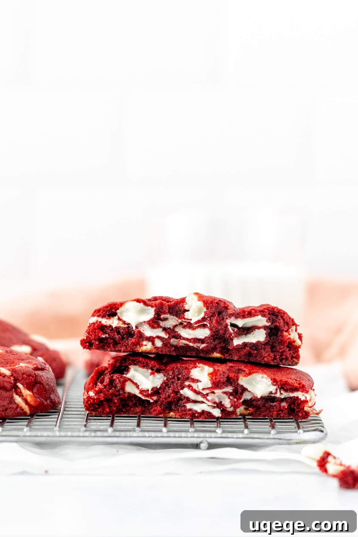 Plush Red Velvet Bakery Cookies 4 Close-up of a stack of bakery-style red velvet cookies with a gooey white chocolate center