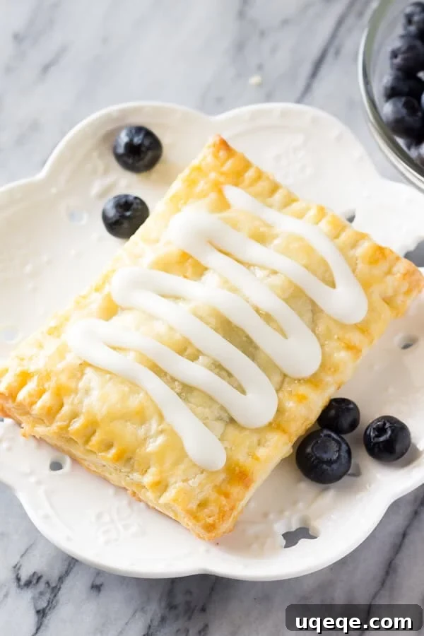 Flaky Homemade Blueberry Toaster Strudels 3 Close-up of baked homemade blueberry toaster strudels showing flaky pastry and golden edges.