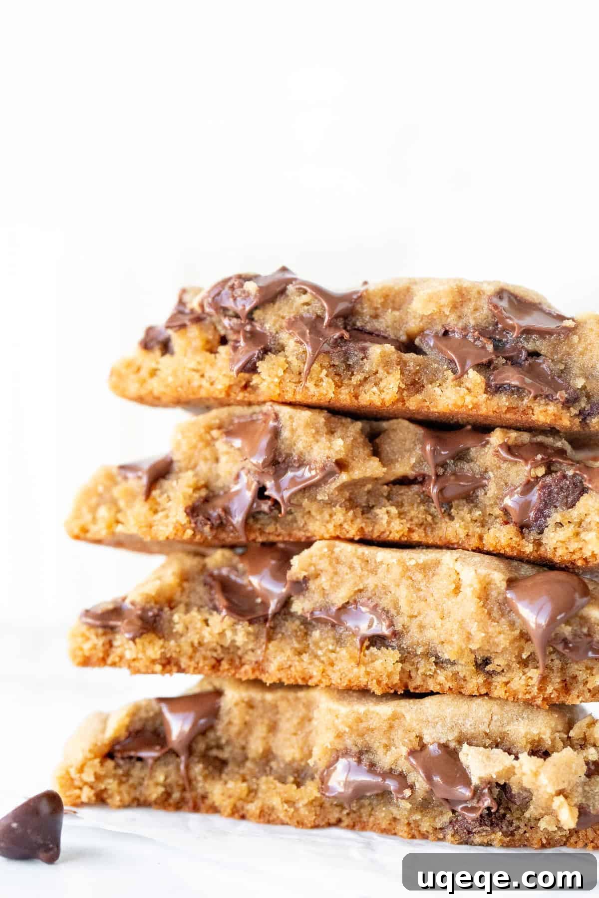 Irresistible Peanut Butter Chocolate Chip Cookies 8 Two chocolate chip peanut butter cookies, one broken in half and stacked on top of a whole cookie, showcasing the rich texture and chocolate.