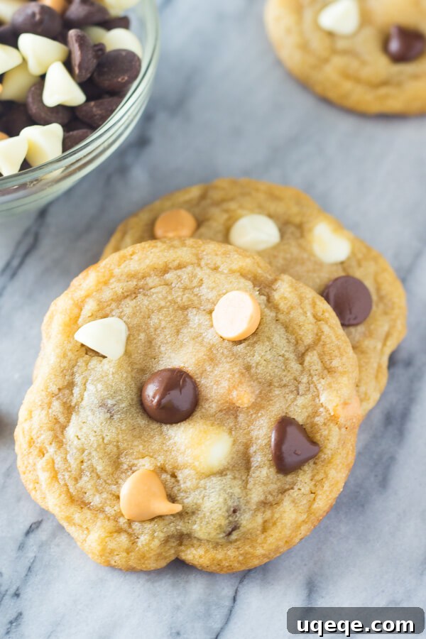 Irresistibly Thin and Chewy Chocolate Chip Cookies 5 An overhead shot of Thin Chewy Chocolate Chip Cookies arranged on a cooling rack, showcasing their uniform thinness, golden sheen, and melted chocolate pools. A perfect no-chill recipe for enthusiasts.