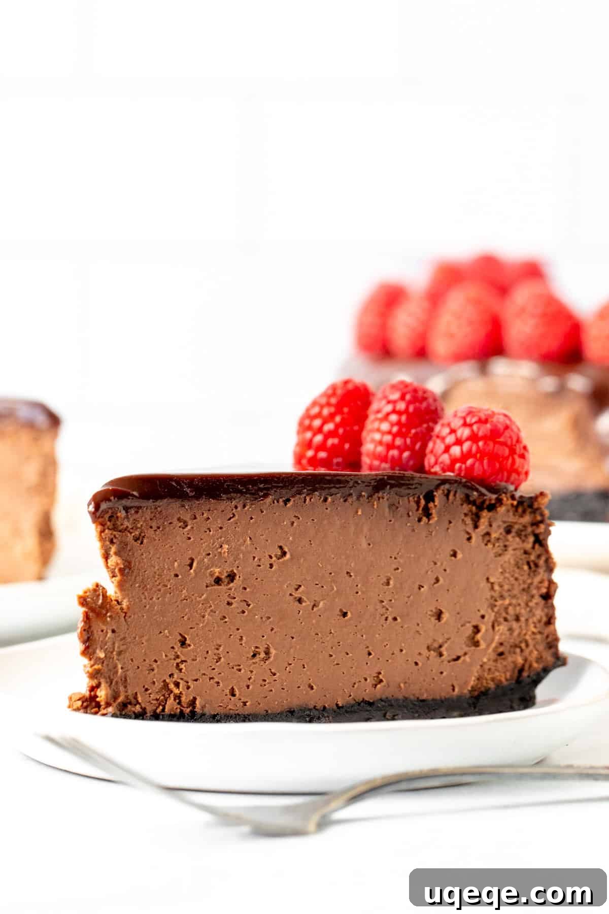 Ultimate Chocolate Cheesecake with Ganache and Berries A beautifully presented chocolate cheesecake with a thick ganache topping and fresh berries, showcasing its decadent appearance.