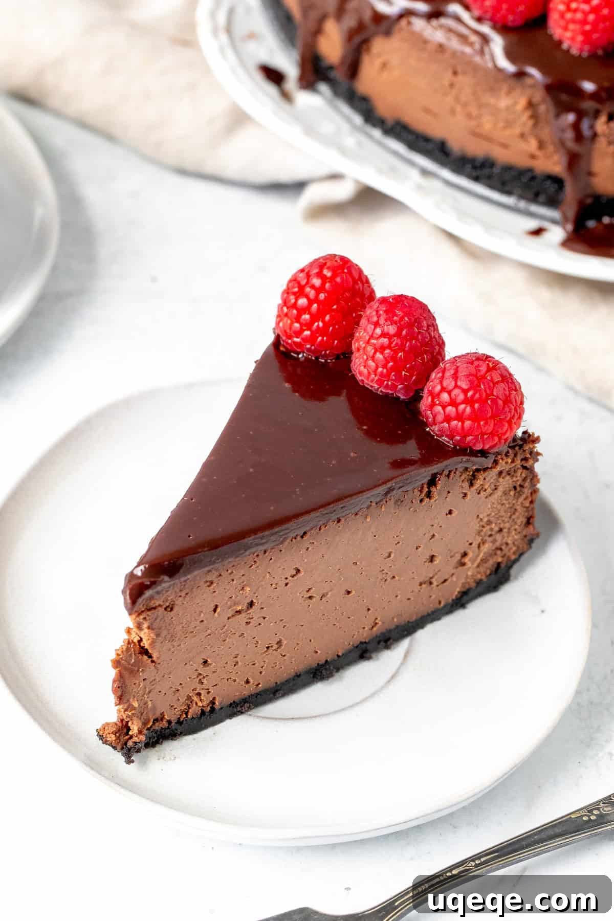 Slice of Triple Chocolate Cheesecake A perfect slice of triple chocolate cheesecake with a glossy chocolate ganache topping, ready to be enjoyed.
