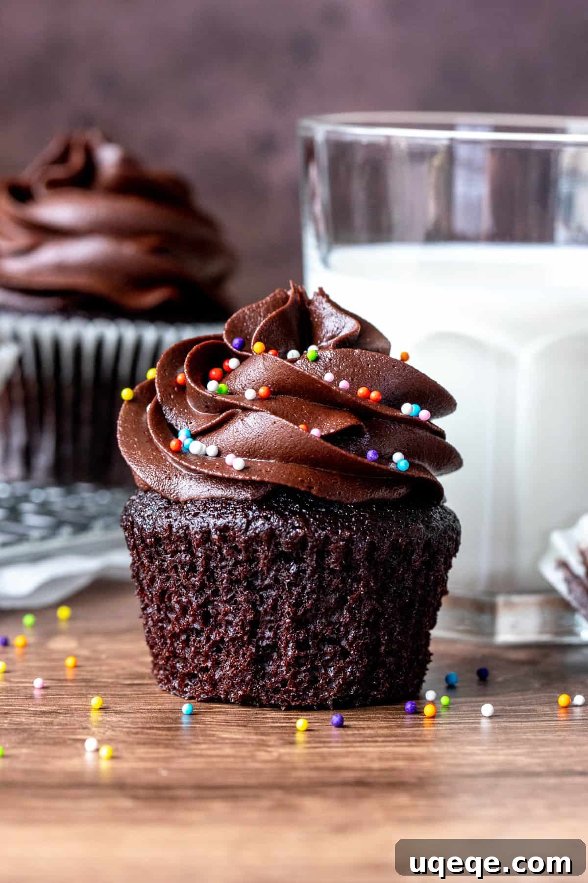 Pure Double Chocolate Indulgence 3 A perfectly baked, moist chocolate cupcake with its paper removed, next to a glass of milk
