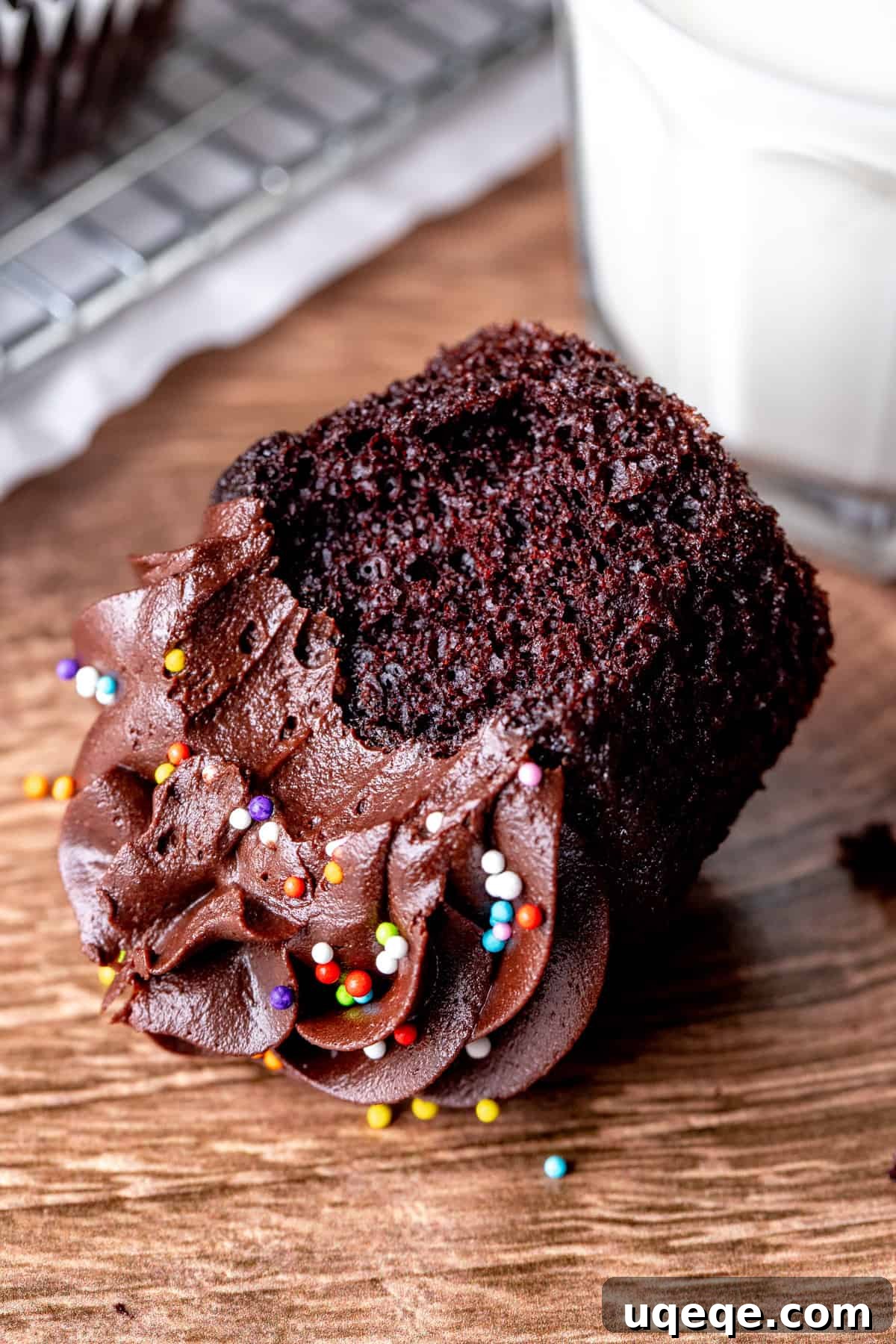 Pure Double Chocolate Indulgence 6 A double chocolate cupcake with a bite taken out, revealing its moist, fudgy interior
