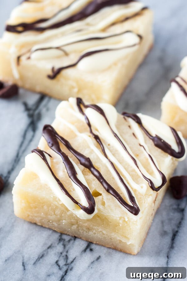 Velvet White Chocolate Squares 4 Beautifully Drizzled White Chocolate Brownies, cut into squares.