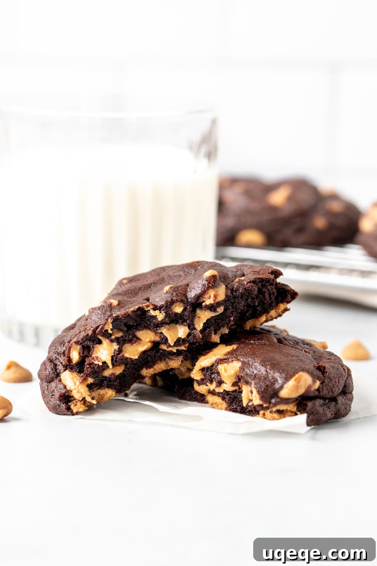 Peanut Butter Dark Chocolate Chip Delights 5 A dark chocolate peanut butter chip cookie, broken in half, next to a refreshing glass of milk, highlighting the perfect pairing.