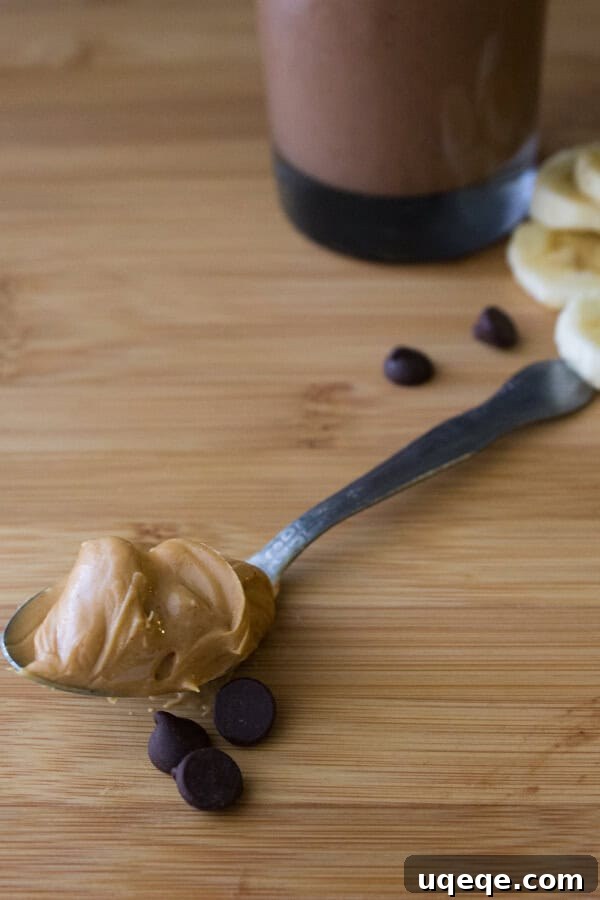 Decadent Chocolate Peanut Butter Banana Delight 3 Side view of a thick Chocolate Peanut Butter Banana Smoothie in a glass, dairy-free and healthy