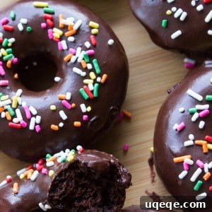 Overhead view of baked chocolate donuts dipped in chocolate.