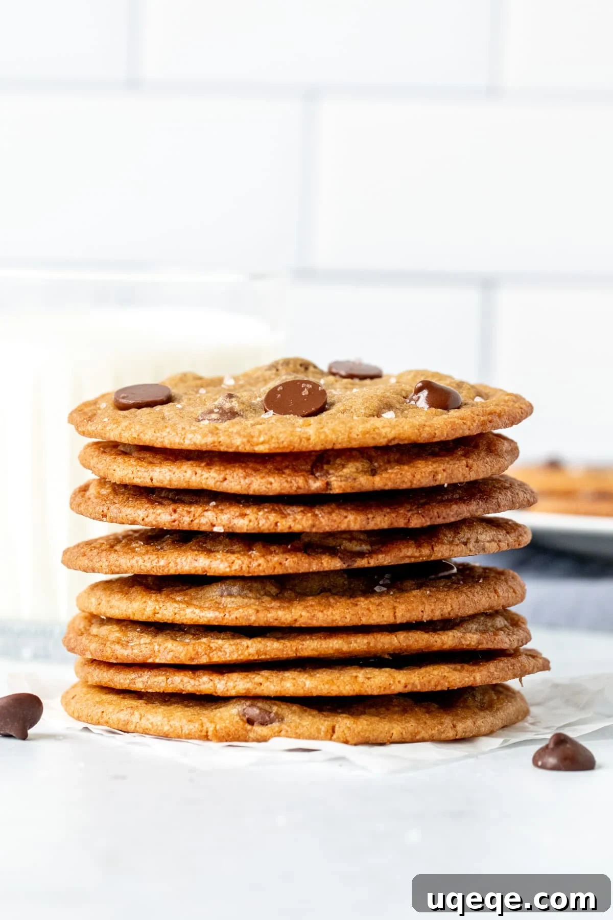 Thin chocolate chip cookies, artfully stacked on top of each other, showcasing their delicate structure and inviting appearance.