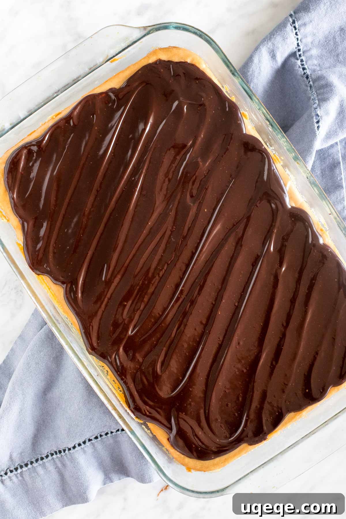 9x13 inch pan of peanut butter chocolate cheesecake. 
