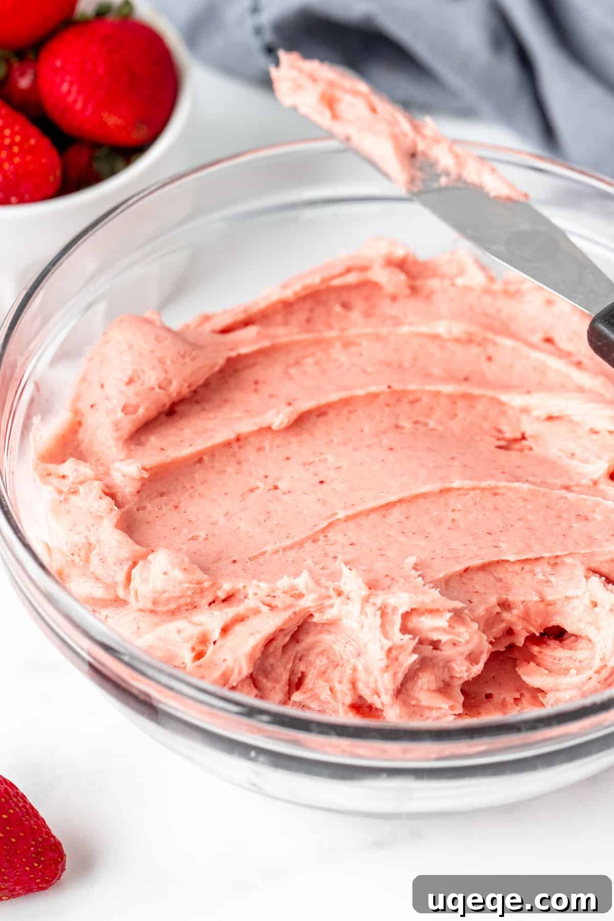 Strawberry Buttercream Delight: Crafted with Fresh or Frozen Berries 3 A bowl filled with luscious, creamy strawberry frosting, ready for decorating.