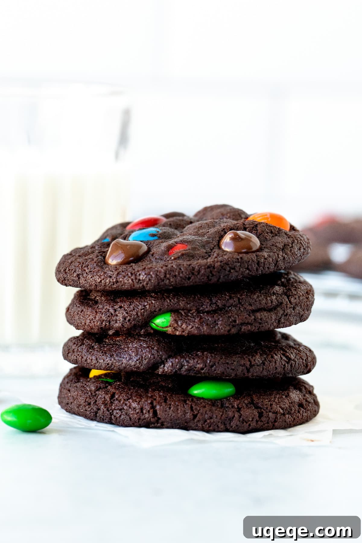 Rainbow Candy Chocolate Cookies 4 M&M chocolate cookies, placed on top of each other with glass of milk, showcasing their vibrant colors