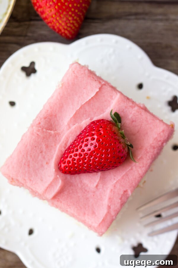 Strawberry Swirl Vanilla Dream 3 Close-up of a fluffy vanilla cake with strawberry frosting, showing the beautiful pink color of the frosting and the tender crumb of the cake. It highlights the fresh strawberry flavor.