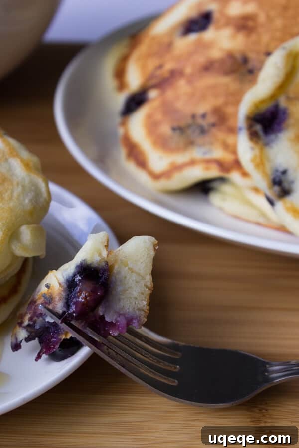 Fluffy Blueberry Buttermilk Stacks 3 Close-up of fluffy Blueberry Buttermilk Pancakes, showcasing their airy texture and juicy blueberries. Get the best homemade pancake recipe.