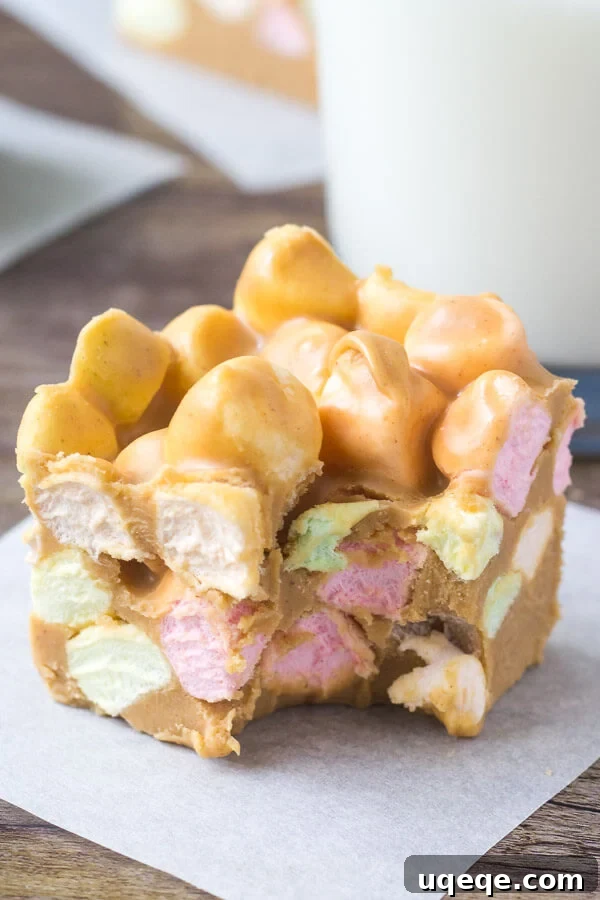 Speckled Peanut Butter Marshmallow Delights 5 A delicious Confetti Square, with a bite taken out to reveal its soft, chewy interior filled with colorful marshmallows, paired with a tall glass of milk, suggesting the perfect nostalgic snack.