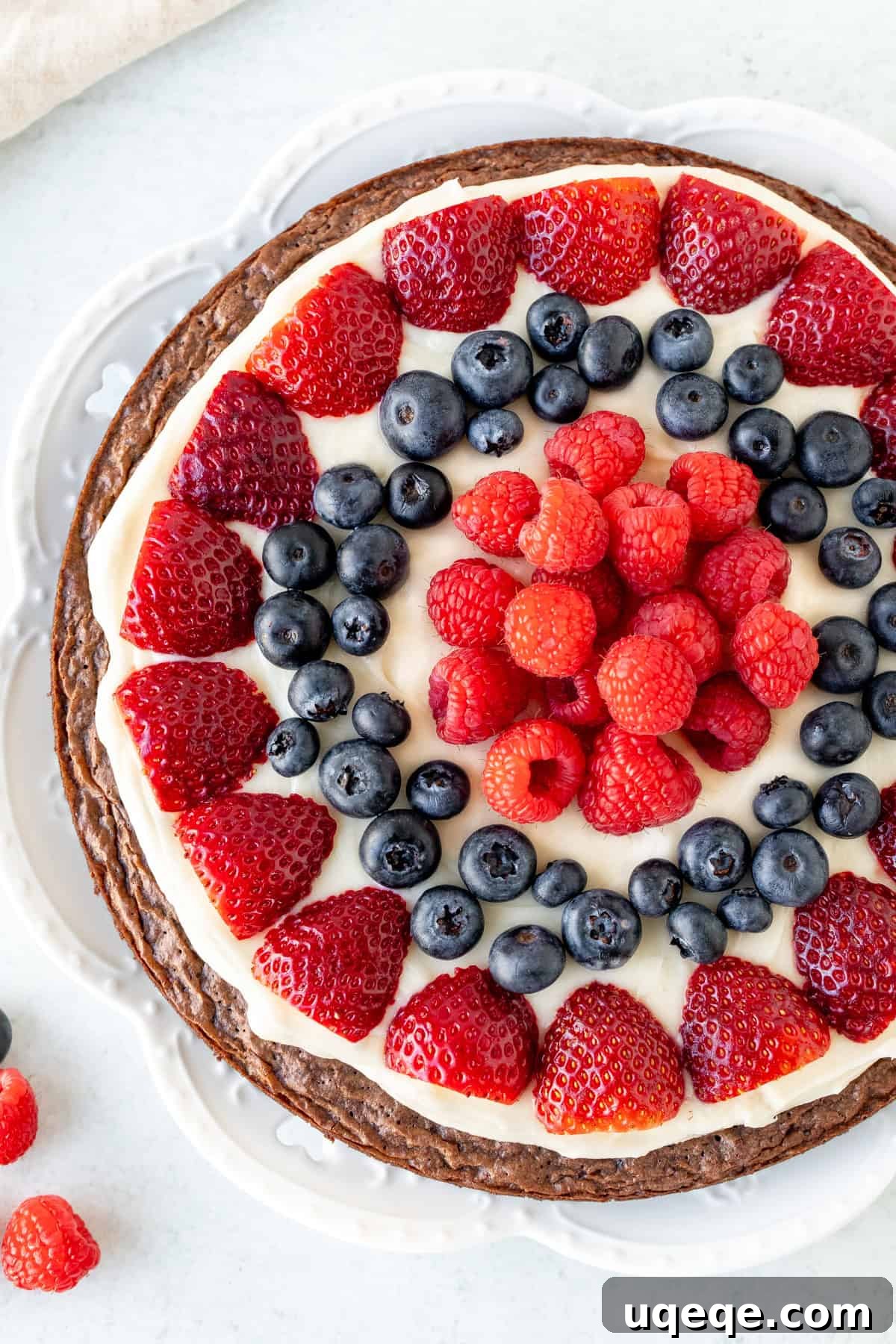 Fudge Brownie Fruit Pizza 6 This brownie fruit pizza starts with a fudgy, chewy brownie as your pizza base. Then there's a layer of tangy cream cheese frosting, and tons of fresh berries. The perfect fruit pizza for anyone who loves brownies! #browniefruitpizza #browniepizza #fruitpizza from Just So Tasty