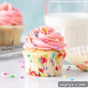 Sprinkle cupcake with vanilla frosting with paper removed